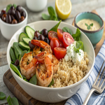 Mediterranean shrimp bowl with shrimp, grains, and fresh veggies