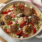 Greek meatballs orzo with chicken meatballs, herbs, and feta cheese in ceramic bowl