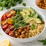 Mediterranean plant protein power bowl with quinoa chickpeas vegetables tahini