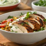 Complete Mediterranean chicken bowl with harissa honey chicken, quinoa, and tzatziki sauce