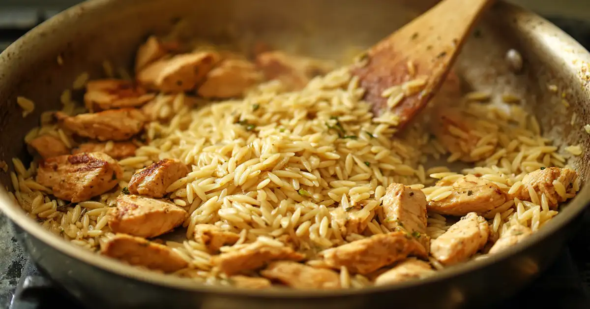 toasting-orzo-pasta-recipe Toasting dry orzo pasta with garlic in skillet for creamy orzo pasta