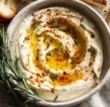 Roasted Garlic and White Bean Dip (Serves 8) 1 Overhead view of smooth white bean dip with olive oil and rosemary garnish