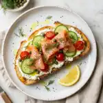 Smoked Salmon Mediterranean Toast: 15 Min Brilliant Meal 2 Overhead view of Mediterranean smoked salmon toast with capers, feta and fresh herbs
