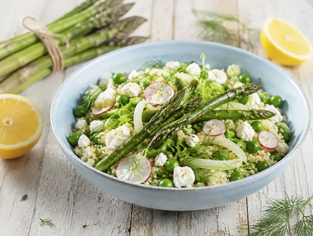 Mediterranean Spring Bowl with Asparagus (33 Minutes) 1 Three-quarter view of mediterranean spring bowl with charred asparagus, peas, quinoa, radish and feta