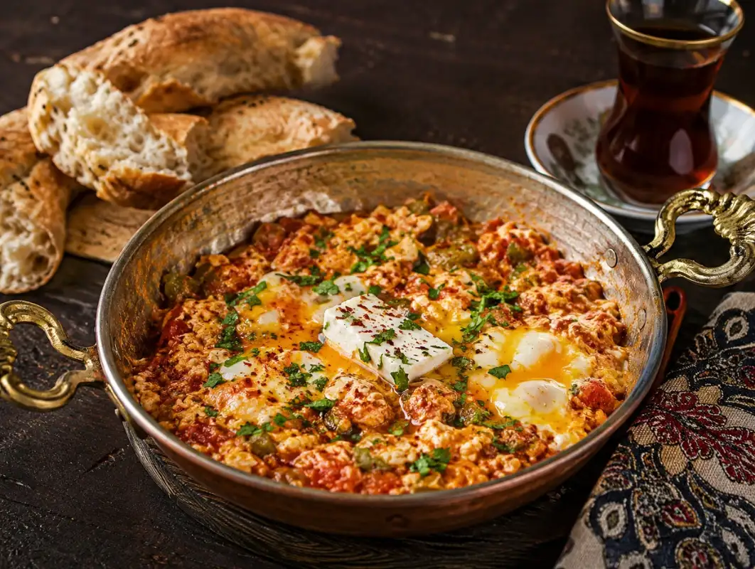 Menemen: Turkish Scrambled Eggs (30 Minutes) 1 Three-quarter view of one-pan Mediterranean chicken pasta with tomatoes, spinach, olives, feta and fresh basil